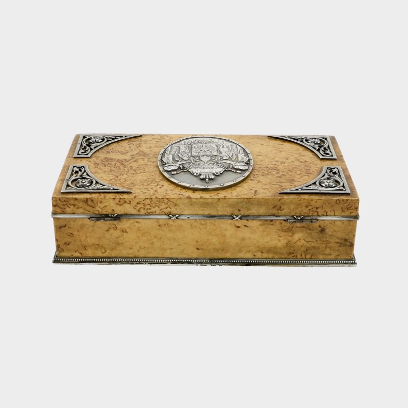 rear side view of Faberge cigar box by Anders Nevalainen with silver coat of arms in center and silver corner floral scrolls