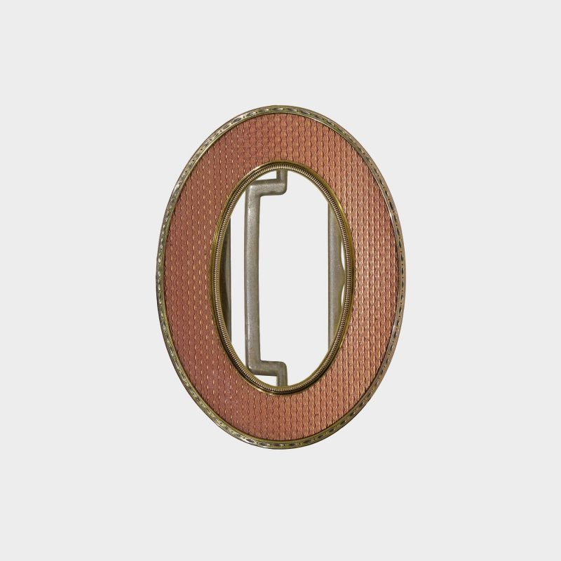 Faberge belt buckle by Henrik Wigstrom enameled in salmon pink guilloche enamel within gold chased borders