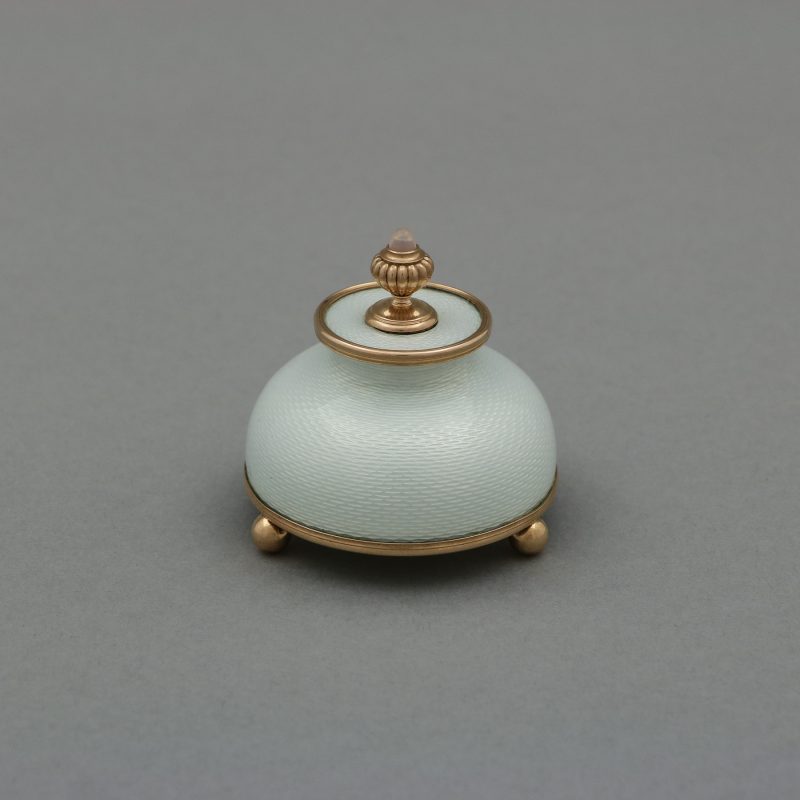 Faberge enamel gum pot by Henrik Wigstrom with dome shaped body enameled in white with round gold mounts and finial