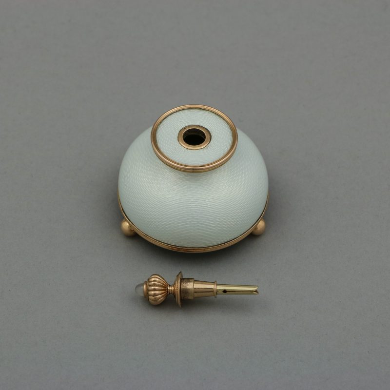 Faberge enamel gum pot by Henrik Wigstrom, dome shaped body enameled in white with round gold mounts and finial