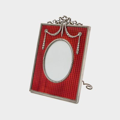 Faberge enamel frame by Anders Nevalainen enameled in red gullioche enamel with silver foliate swags and ribbon crest on top