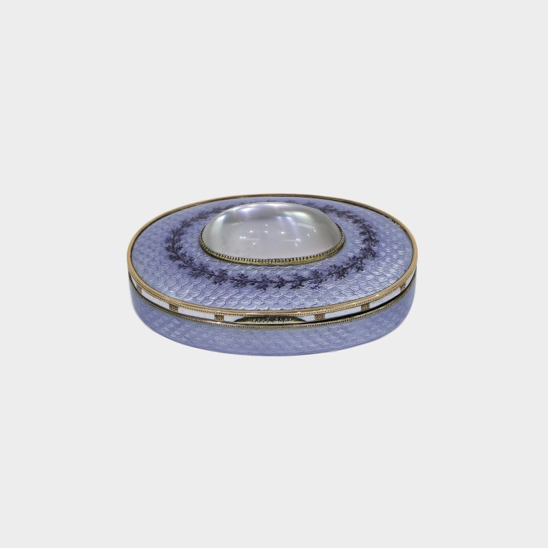 Faberge pill box, of oval form, enameled in lilac guilloche enamel with cabochon moonstone centering hinged lid