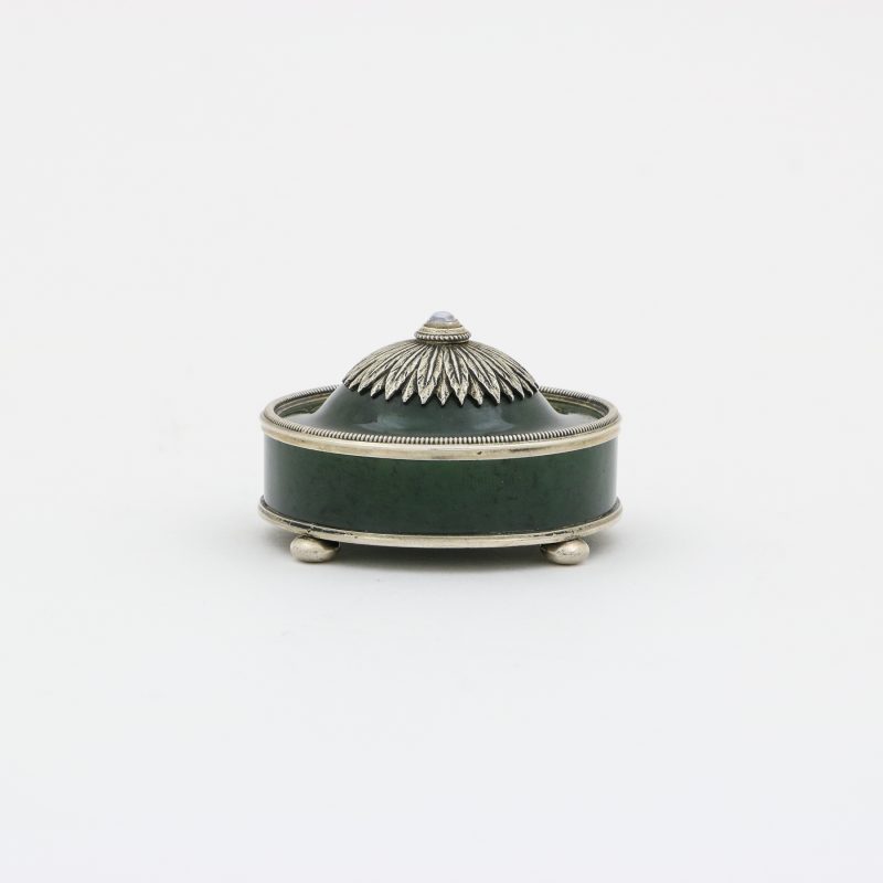 side view of Faberge bell push by Johan Victor Aarne of circular shape with silver decorations on top