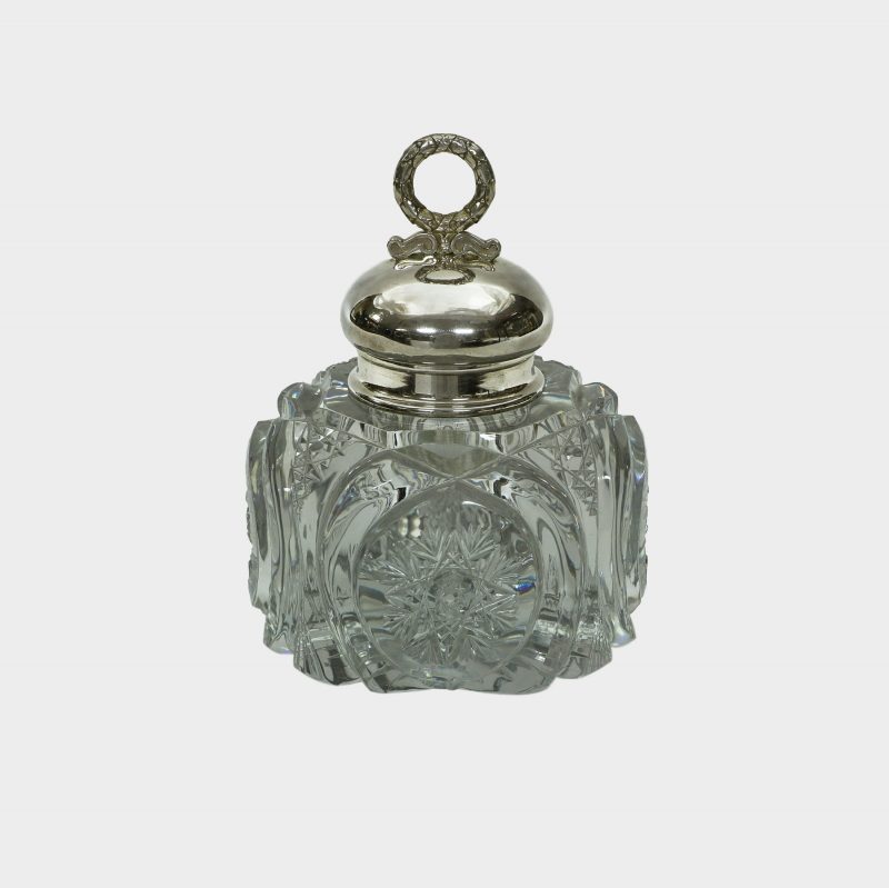Faberge cut-glass inkwell with domed silver lid surmounted by laurel wreath finial, shown without stand