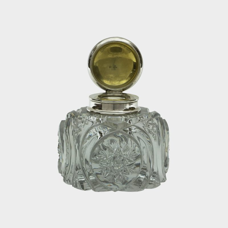 Faberge cut-glass inkwell without stand with domed silver lid open showing hallmarks on gilded inside of lid