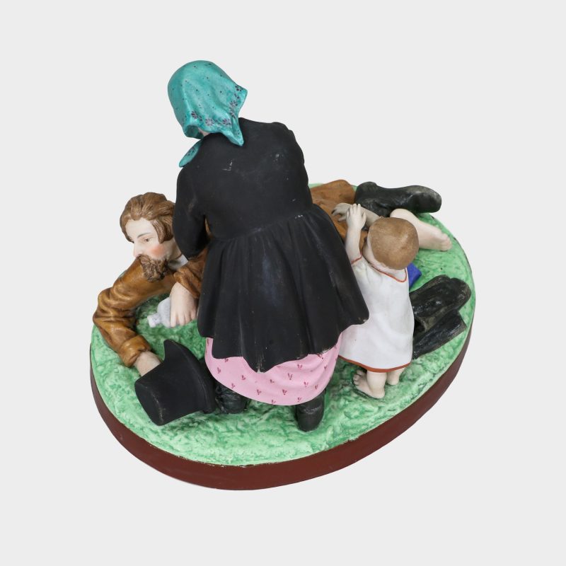 Russian porcelain group modeled as drunken man lying on ground and his wife with kid next to her trying to pick him up