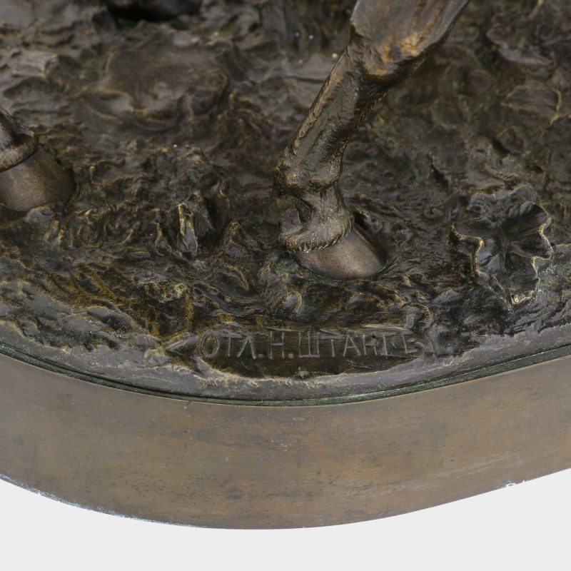 close-up of foundry mark on Russian sculpture of cossack on horse wiping blood off his sword with his horse's mane