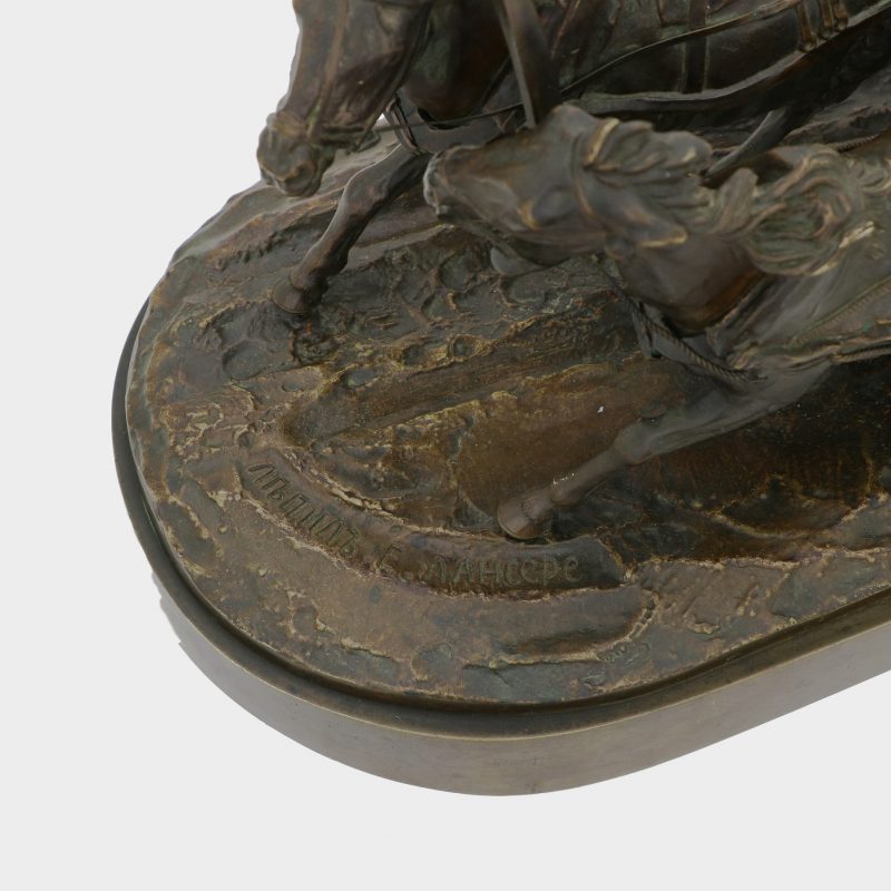 close-up of signature on Russian sculpture cast as man and woman riding on sled pulled by two horses
