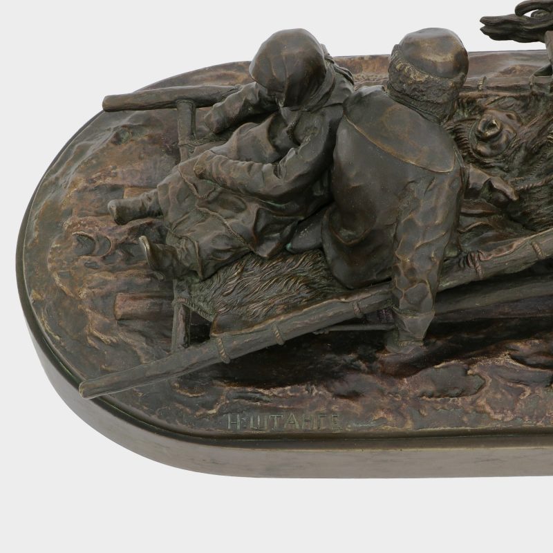 close-up of foundry mark on Russian sculpture cast as man and woman riding on sled pulled by two horses