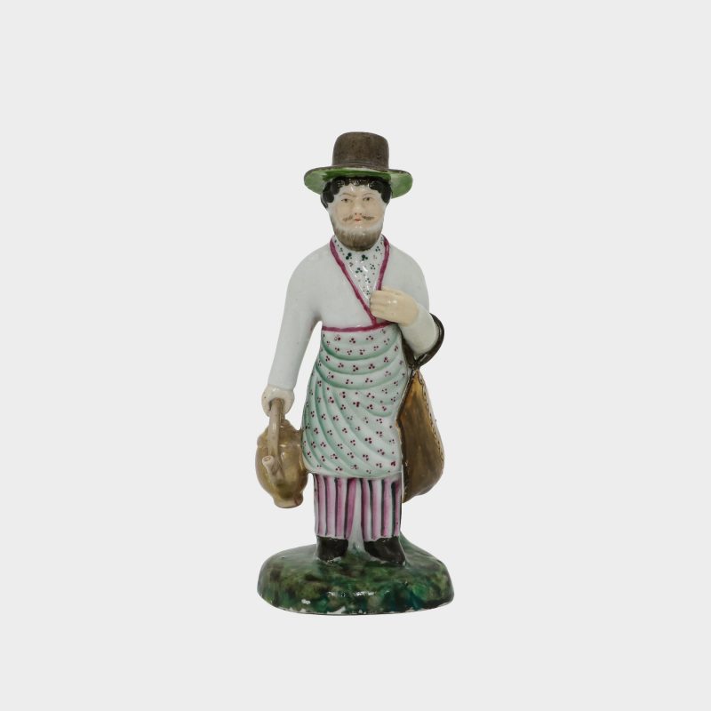 Russian porcelain figurine modeled as street vendor of sbiten (Russian drink)