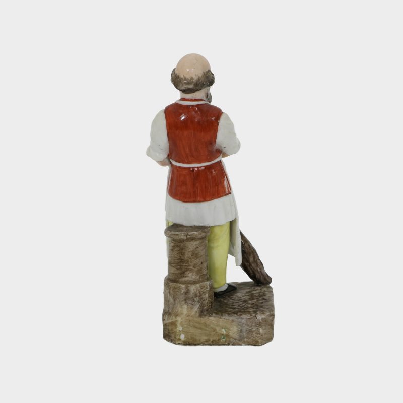 Russian porcelain figurine modeled as yard keeper, holding a broom