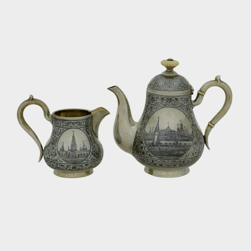 milk jug and tea pot from Russian silver tea set, 7 piece silver niello set depicting views of Moscow with gilded interiors