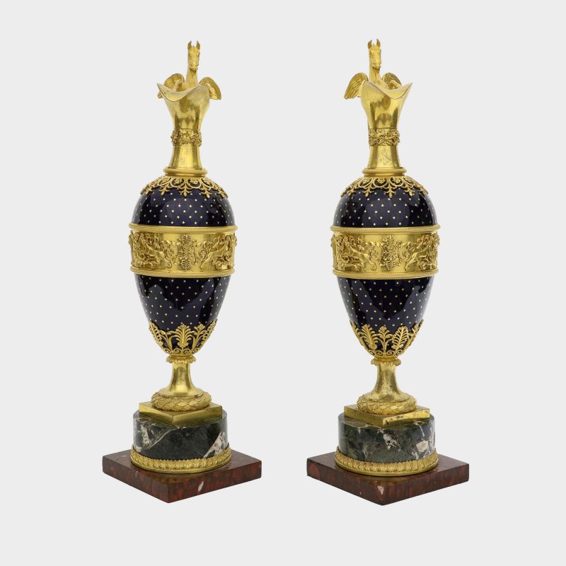 front view of pair of ewers, probably Russian, ovoid body enameled with stars, with Pegasus-formed ormolu handles