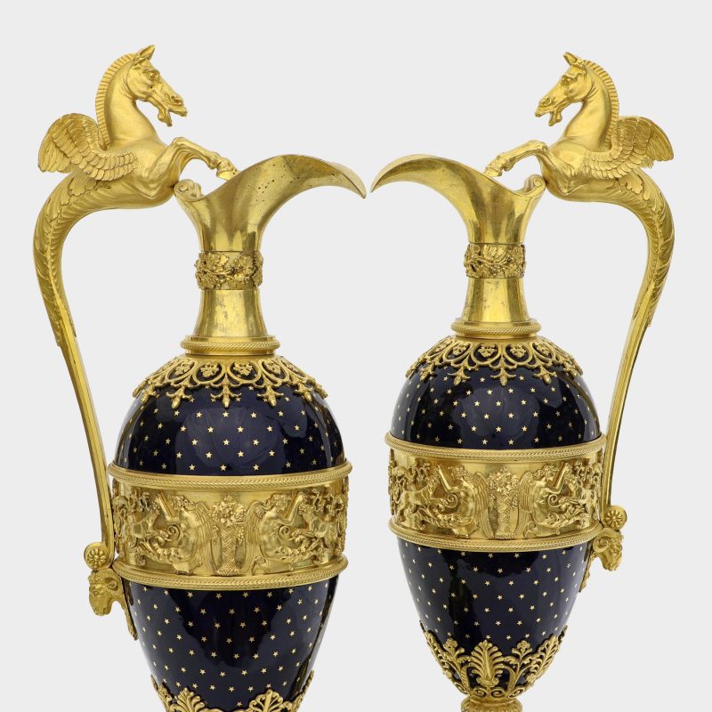 close-up of top half of pair of jugs with ovoid body enameled with stars, with Pegasus-formed ormolu handles