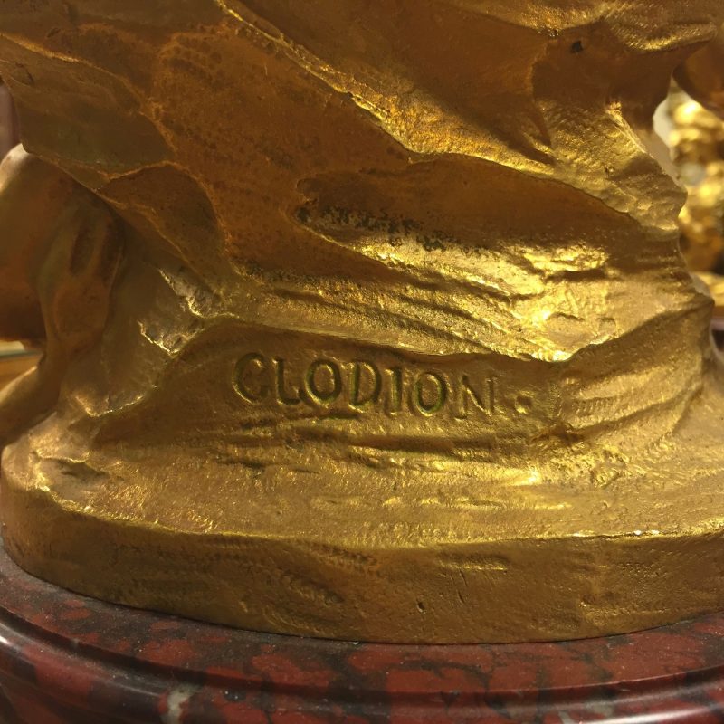 close-up of signature on gilded sculpture of satyr