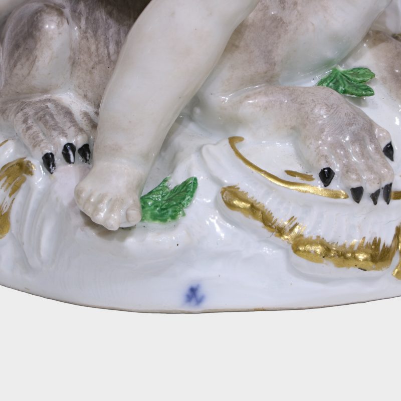 close-up of blue crossed swords mark on porcelain figurine emblematic of America and Europe