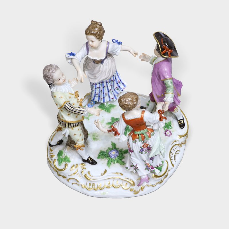 top view of meissen porcelain figure modeled as four children dressed in 18th century clothing playing ring around rosie