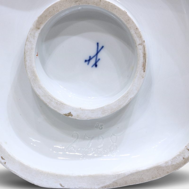 close-up of blue crossed swords mark on porcelain figurine "ring around the rosie"