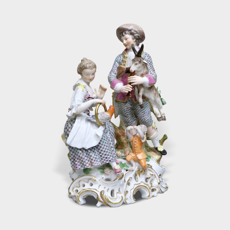 Meissen porcelain figurine modeled as seated lady with bird, gentleman holding goat playing bagpipes, monkey playing flute