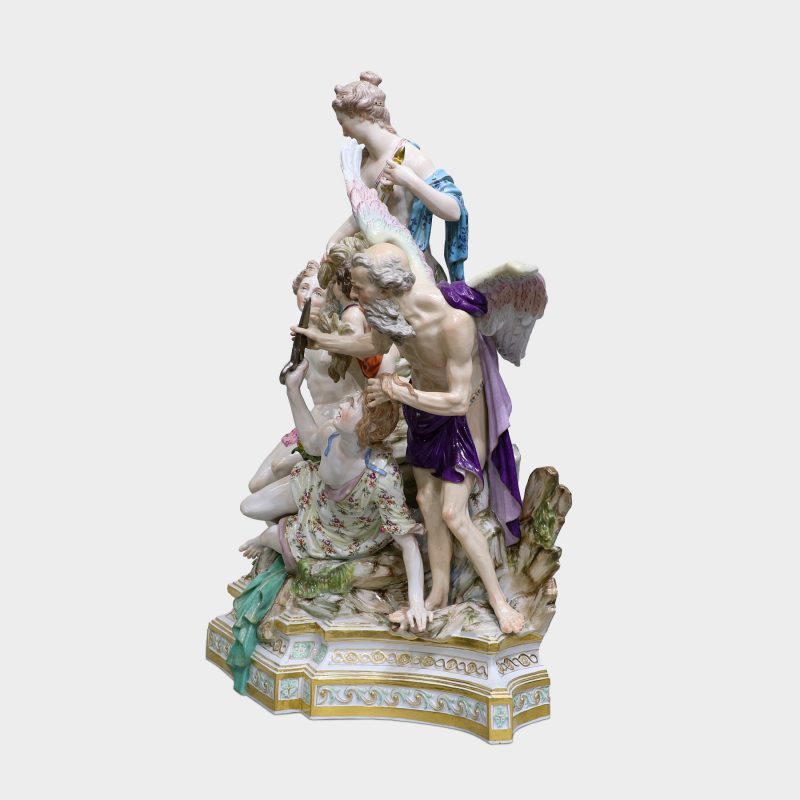 side view of Meissen porcelain group modeled with five figures standing upon a rocky stepped trapezoidal gilt-enriched base